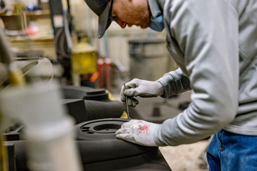 A man inspecting a cast.