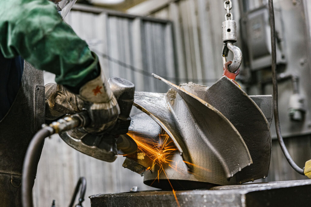 A man performing quality control testing on a part.