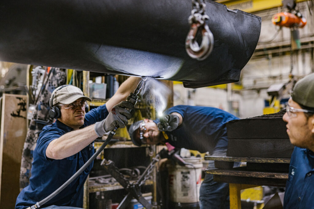 Three men working in the foundry.