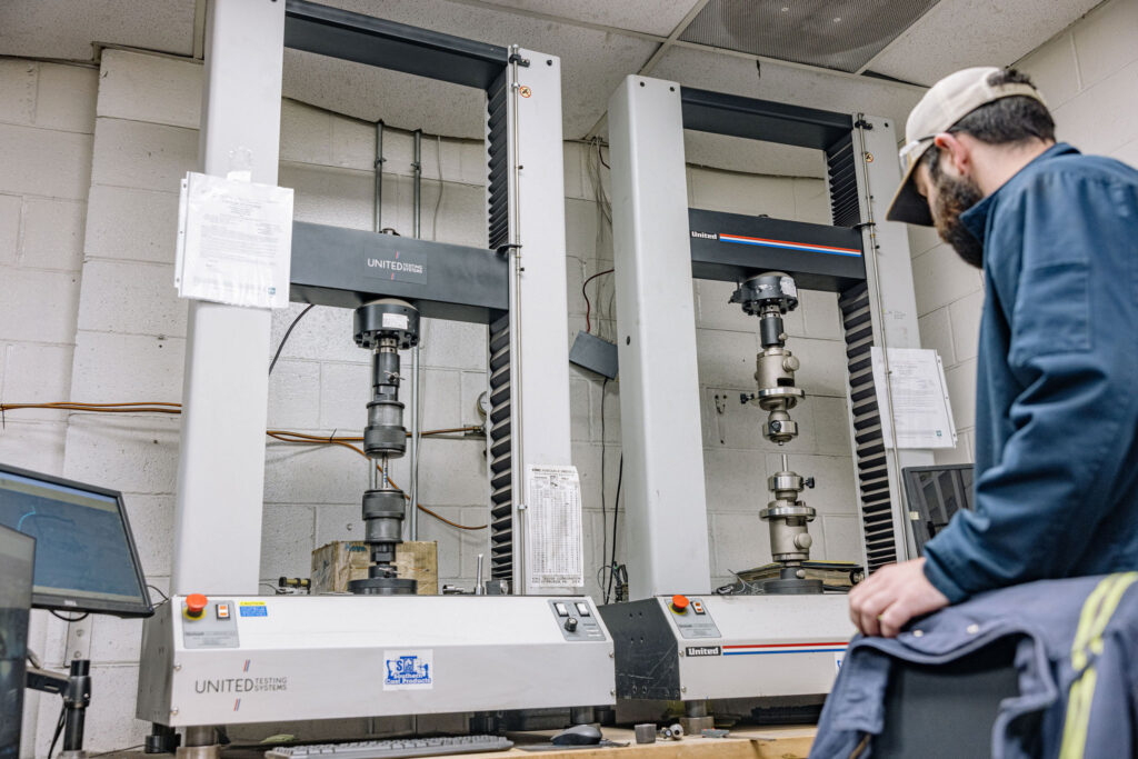 A man standing in the quality control / inspection lab at Southern Cast Products.